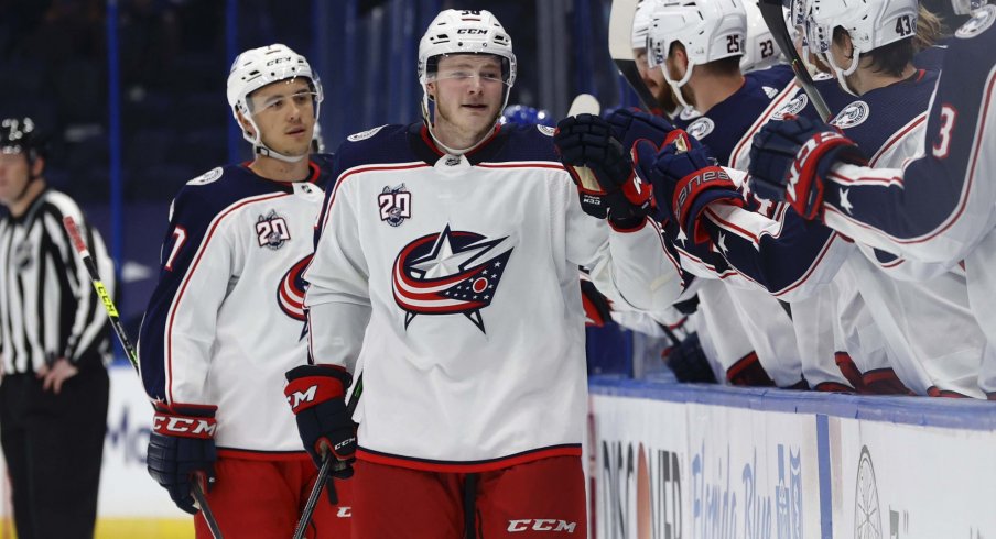 Apr 25, 2021; Tampa, Florida, USA; Columbus Blue Jackets left wing Eric Robinson (50) is congratulated as he scores a goal against the Tampa Bay Lightning during the third period at Amalie Arena.