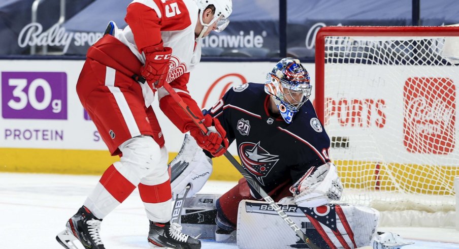 Apr 27, 2021; Columbus, Ohio, USA; Columbus Blue Jackets goaltender Elvis Merzlikins (90) makes a save in net against Detroit Red Wings left winger Jakub Vrana (15) in the overtime period at Nationwide Arena.