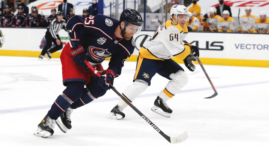 May 5, 2021; Columbus, Ohio, USA; Columbus Blue Jackets center Mikhail Grigorenko (25) controls the puck as enters the zone against the Nashville Predators during the first period at Nationwide Arena.