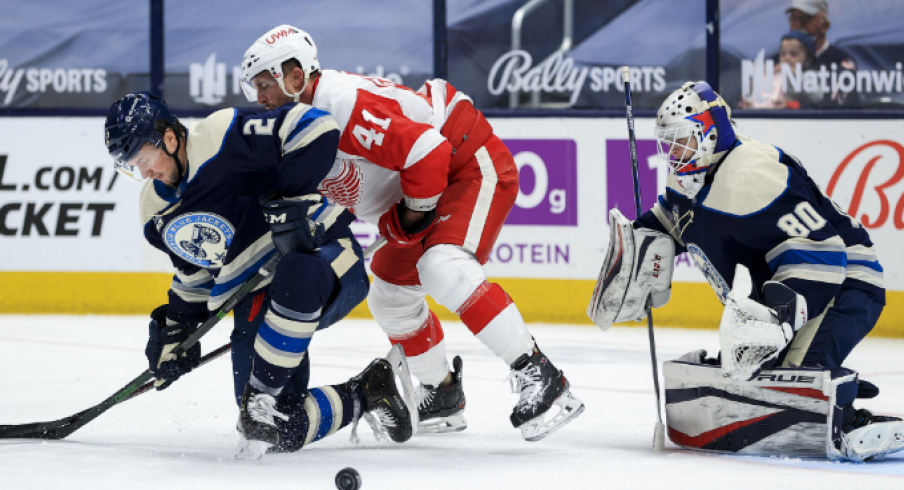 Columbus Blue Jackets defenseman Andrew Peeke (2) reacts after blocking a shot in front of Detroit Red Wings center Luke Glendening (41) as Columbus Blue Jackets goaltender Matiss Kivlenieks (80) defends the net in the second period at Nationwide Arena.