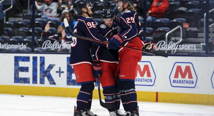 May 8, 2021; Columbus, Ohio, USA; Columbus Blue Jackets right wing Cam Atkinson (middle) celebrates with teammates center Jack Roslovic (left) and right wing Patrik Laine (right) after scoring a goal against the Detroit Red Wings in the 1st period at Nationwide Arena.