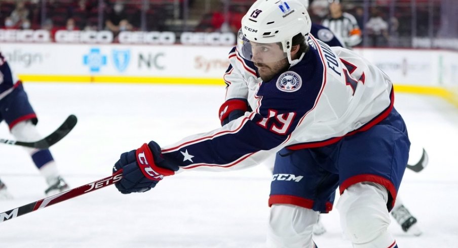  Columbus Blue Jackets center Liam Foudy (19) takes a first period shot against the Carolina Hurricanes at PNC Arena.