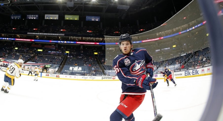 Columbus Blue Jackets center Jack Roslovic (96) passes the puck off the glass during the first period against the Nashville Predators at Nationwide Arena.