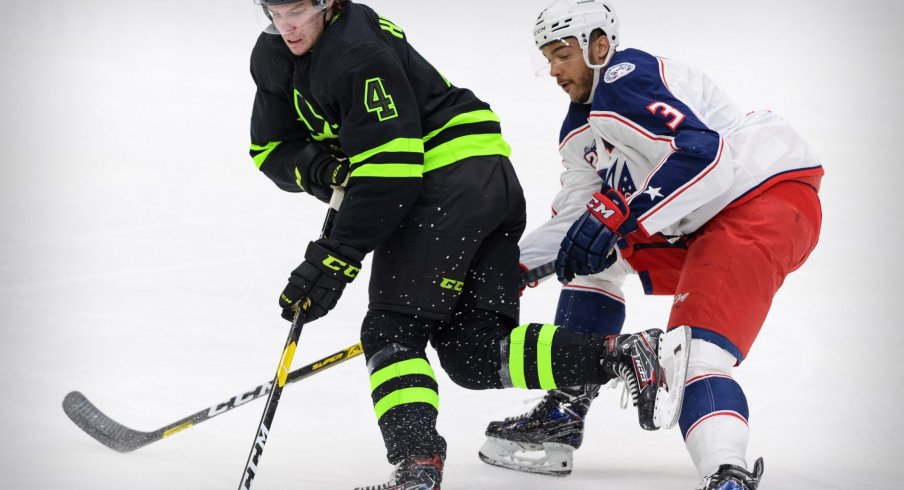 Mar 6, 2021; Dallas, Texas, USA; Dallas Stars defenseman Miro Heiskanen (4) is tripped by Columbus Blue Jackets defenseman Seth Jones (3) during the first period at the American Airlines Center.