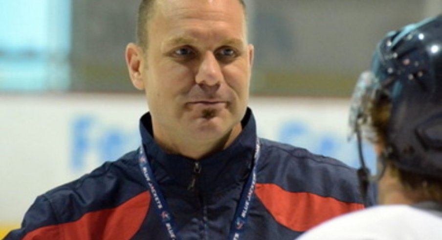 Brad Larsen talks to a player at the Ice Haus and preps them during practice