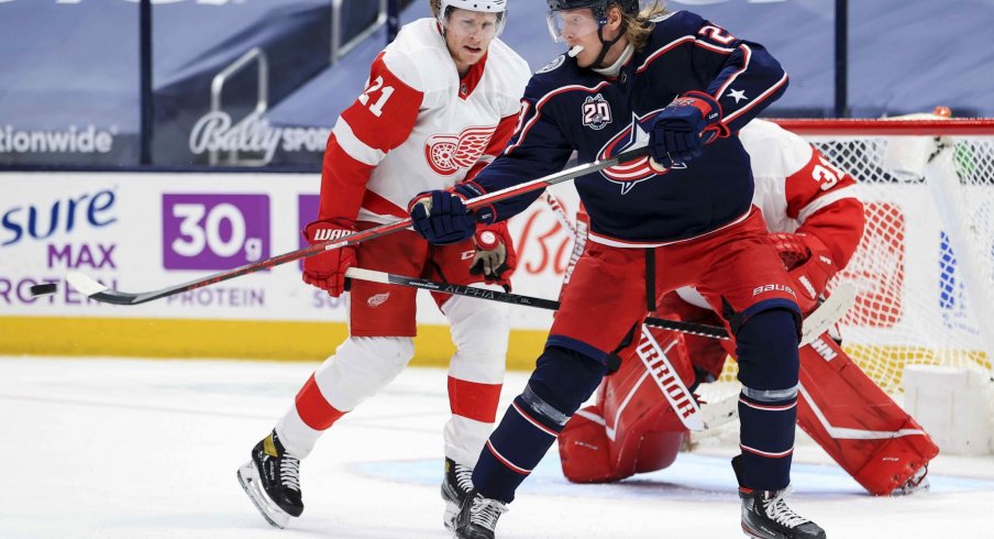 May 8, 2021; Columbus, Ohio, USA; Columbus Blue Jackets right wing Patrik Laine (29) deflects the puck in the air along side Detroit Red Wings defenseman Dennis Cholowski (21) in the third period at Nationwide Arena.