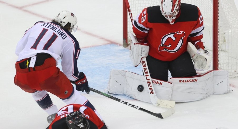 New Jersey Devils goaltender Mackenzie Blackwood (29) makes a save on Columbus Blue Jackets center Kevin Stenlund (11) during overtime at Prudential Center. 