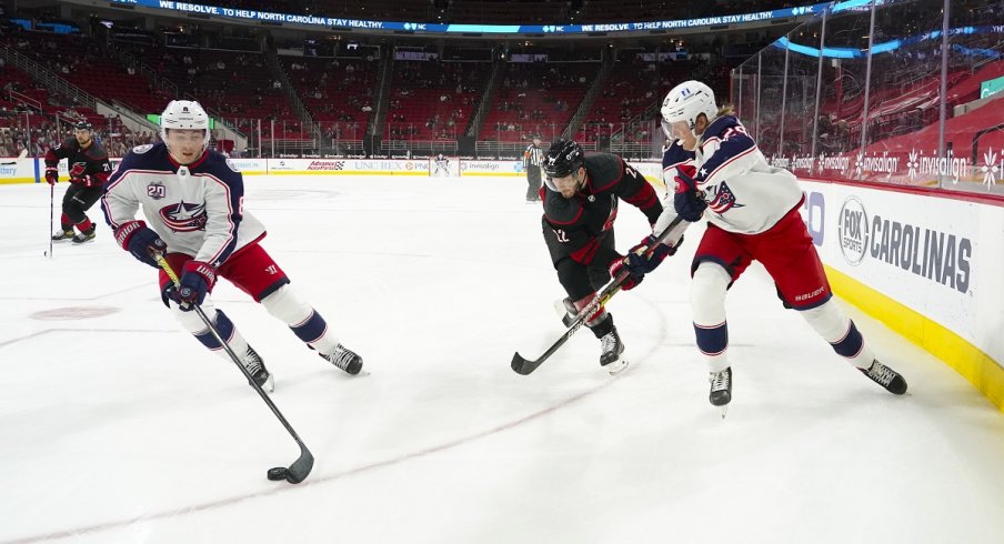 Zach Werenski and Patrik Laine skate against the Carolina Hurricanes