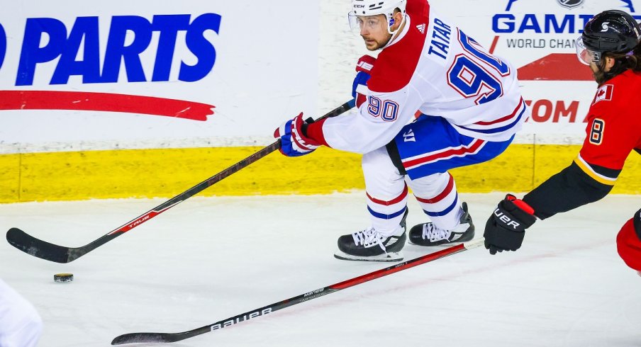 Tomas Tatar protects the puck against the Calgary Flames