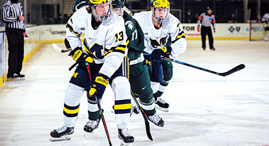 Kent Johnson skates with the puck against Michigan State