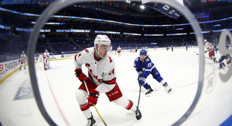 Carolina Hurricanes defenseman Jake Bean (24) skates with the puck as Tampa Bay Lightning center Blake Coleman (20) attempts to defend during the second period at Amalie Arena.