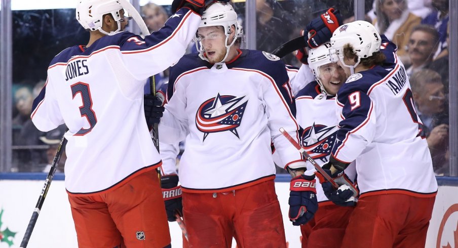 Jones, Dubois, Panarin, and Atkinson celebrate a goal