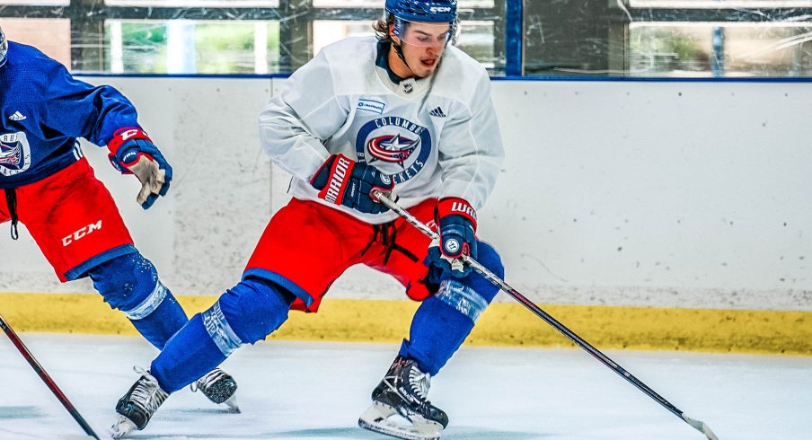 Cole Sillinger controls the puck.