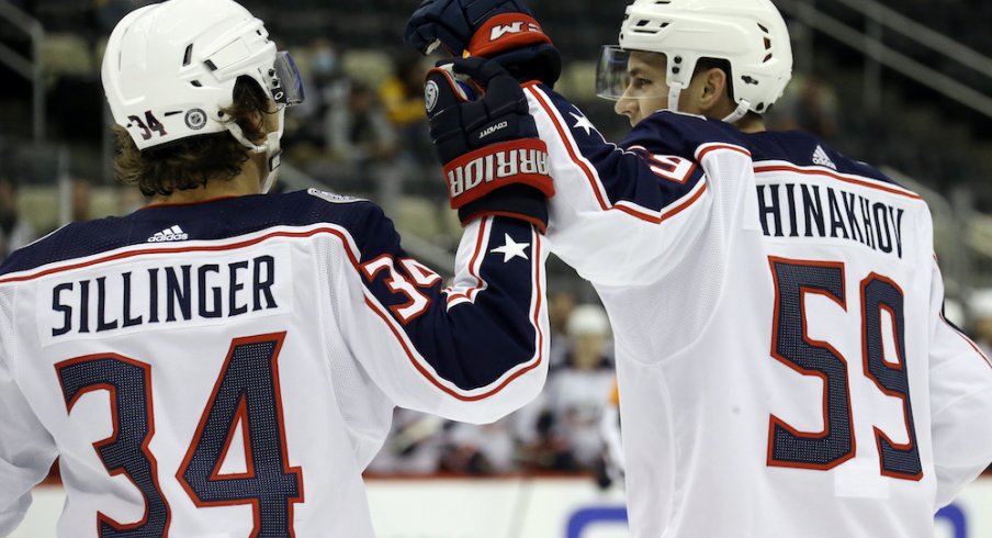 Columbus Blue Jackets forward Yegor Chinakhov (59) celebrates with forward Cole Sillinger (34) after scoring a goal against the Pittsburgh Penguins during the first period at PPG Paints Arena.