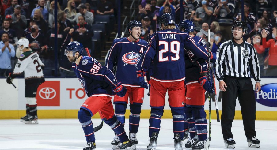 Oct 14, 2021; Columbus, Ohio, USA; Columbus Blue Jackets right wing Oliver Bjorkstrand (28) celebrates with teammates after scoring a goal against the Arizona Coyotes in the first period at Nationwide Arena.
