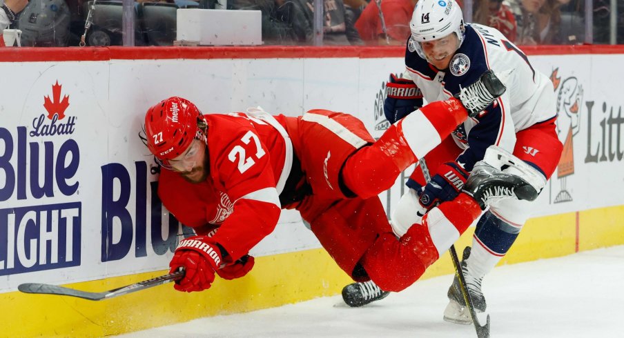 Oct 19, 2021; Detroit, Michigan, USA; Detroit Red Wings center Michael Rasmussen (27) and Columbus Blue Jackets center Gustav Nyquist (14) battle for the puck in the second period at Little Caesars Arena.