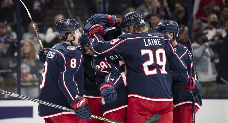 Oct 21, 2021; Columbus, Ohio, USA; Columbus Blue Jackets center Boone Jenner (38) celebrates with his team after scoring a goal against the New York Islanders in the second period at Nationwide Arena.