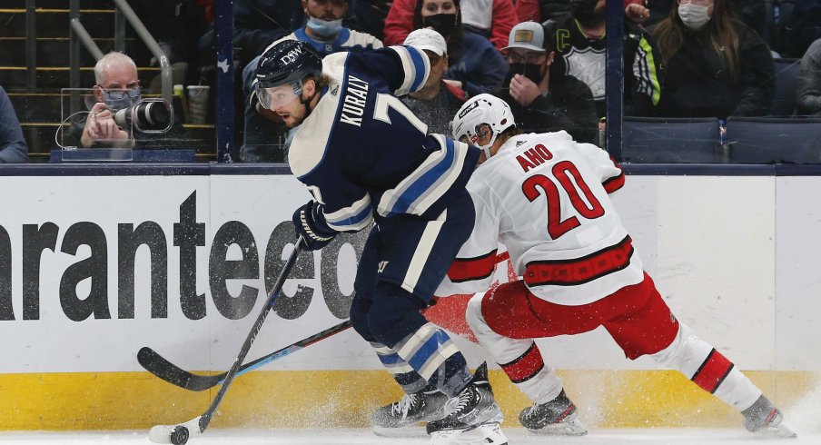 Oct 23, 2021; Columbus, Ohio, USA; Columbus Blue Jackets center Sean Kuraly (7) and Carolina Hurricanes left wing Sebastian Aho (20) battle for the puck during the first period at Nationwide Arena.