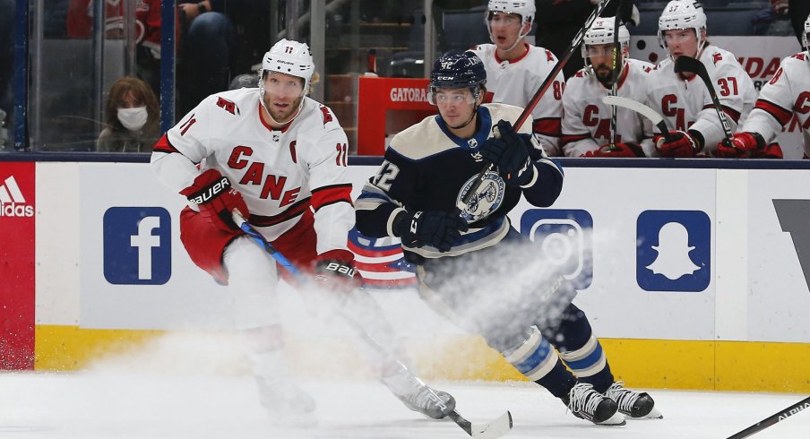 Oct 23, 2021; Columbus, Ohio, USA; Carolina Hurricanes center Jordan Staal (11) and Columbus Blue Jackets center Alexandre Texier (42) battle for the puck during the first period at Nationwide Arena.