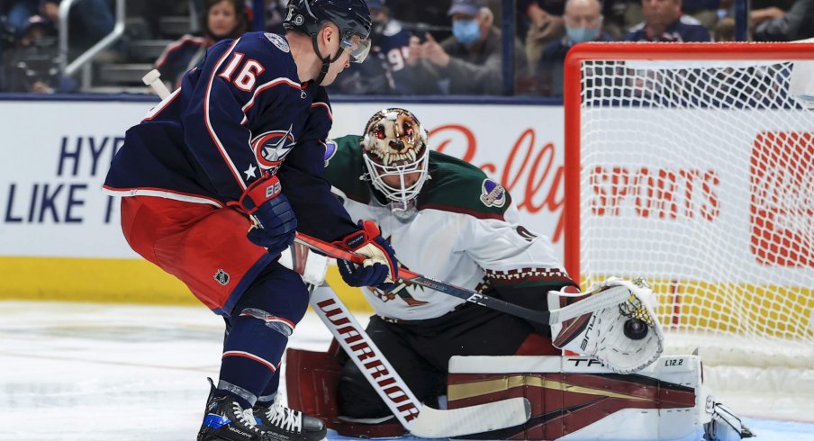 Oct 14, 2021; Columbus, Ohio, USA; Columbus Blue Jackets center Max Domi (16) takes a shot on goal as Arizona Coyotes goaltender Carter Hutton (40) makes a glove save in the third period at Nationwide Arena.