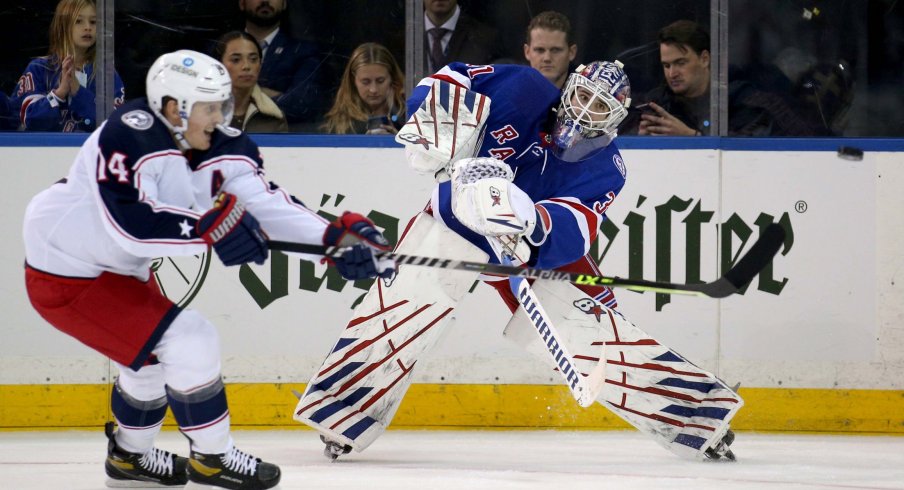 Oct 29, 2021; New York, New York, USA; New York Rangers goaltender Igor Shesterkin (31) plays the puck past Columbus Blue Jackets center Gustav Nyquist (14) during the second period at Madison Square Garden.