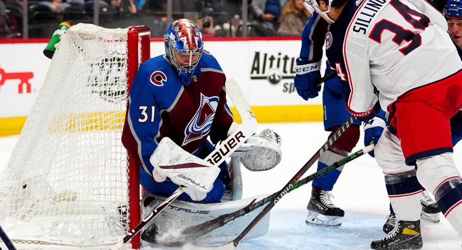 Nov 3, 2021; Denver, Colorado, USA; Colorado Avalanche goaltender Jonas Johansson (31) makes a save on Columbus Blue Jackets center Cole Sillinger (34) in the first period at Ball Arena.