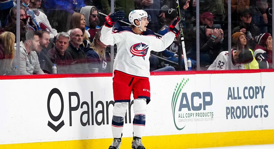 Nov 3, 2021; Denver, Colorado, USA; Columbus Blue Jackets defenseman Jake Bean (22) celebrates his overtime winning goal against the Colorado Avalanche at Ball Arena.