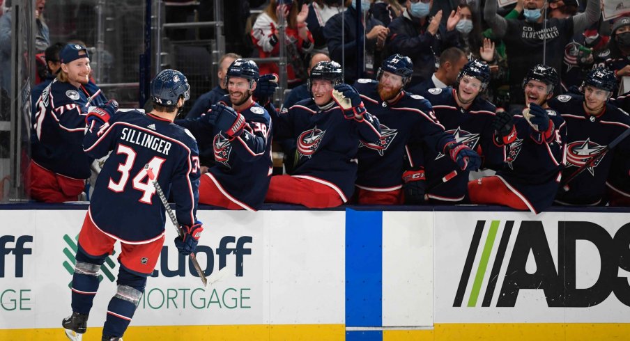 Oct 21, 2021; Columbus, Ohio, USA; Columbus Blue Jackets center Cole Sillinger (34) celebrates with his team after scoring a goal against the New York Islanders in the second period at Nationwide Arena.