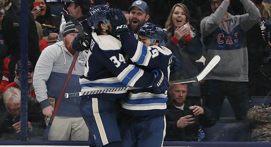 Yegor Chinakhov and Cole Sillinger celebrate Chinakhov's first NHL goal