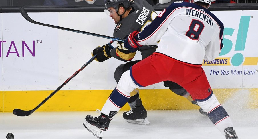Feb 9, 2019; Las Vegas, NV, USA; Columbus Blue Jackets defenseman Zach Werenski (8) checks Vegas Golden Knights left wing William Carrier (28) during the first period at T-Mobile Arena.