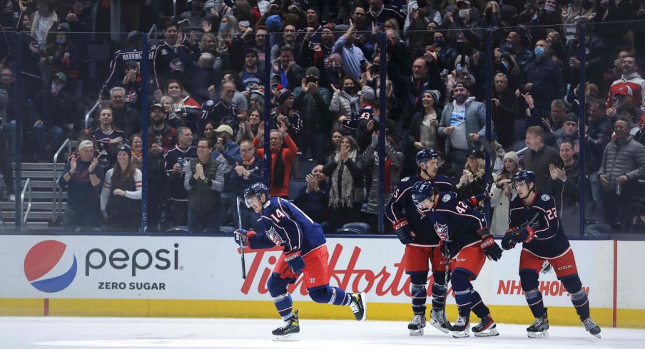 Nov 26, 2021; Columbus, Ohio, USA; Columbus Blue Jackets center Gustav Nyquist (14) celebrates with teammates after scoring a goal against the Vancouver Canucks in the first period at Nationwide Arena.