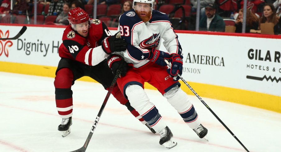 Jakub Voracek protects the puck against Arizona Coyotes defenseman Ilya Lyubushkin