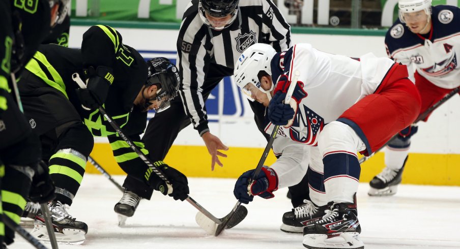 Dallas Stars center Andrew Cogliano (11) and Columbus Blue Jackets center Jack Roslovic (96) in a face off in the second period at American Airlines Center.