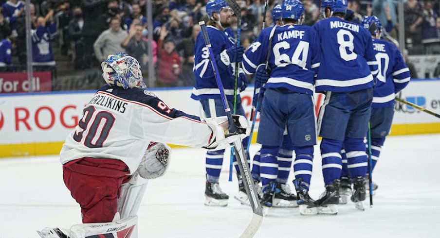 The Toronto Maple Leafs celebrate a goal as Elvis Merzlikins of the Columbus Blue Jackets looks on from Scotiabank Arena.