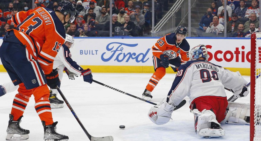 Dec 16, 2021; Edmonton, Alberta, CAN; Edmonton Oilers forward Jesse Puljujarvi (13) scores a first period goal against Columbus Blue Jackets goaltender Elvis Merzlikins (90) at Rogers Place.