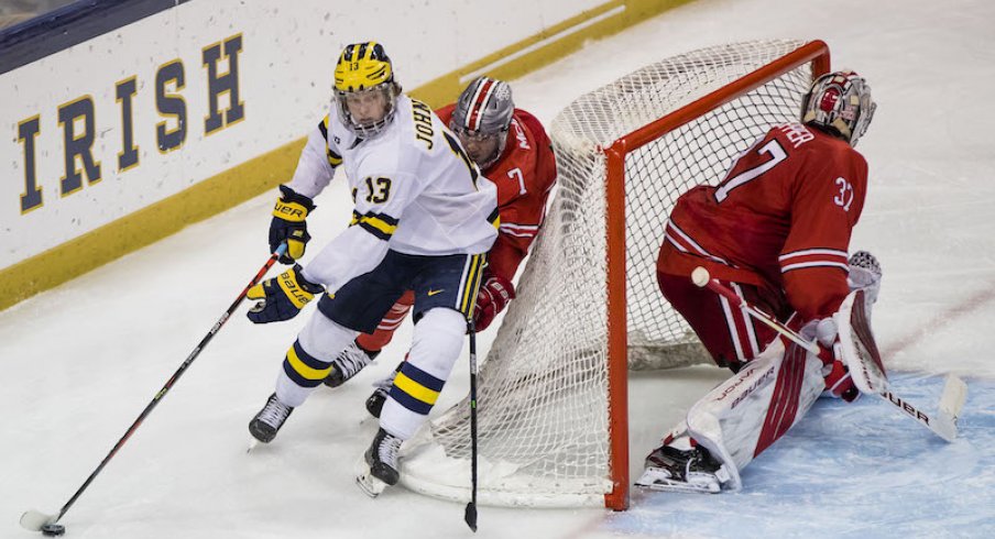 Kent Johnson plays the puck for the Michigan Wolverines against the Ohio State Buckeyes at the Big 10 Hockey Tournament.