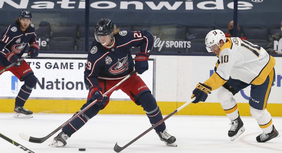 May 5, 2021; Columbus, Ohio, USA; Nashville Predators center Colton Sissons (10) knocks the puck off the stick of Columbus Blue Jackets right wing Patrik Laine (29) during the first period at Nationwide Arena.