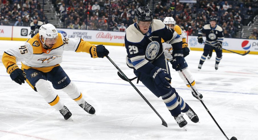 Patrik Laine skates with the puck around defenseman Alexandre Carrier at Nationwide Arena.