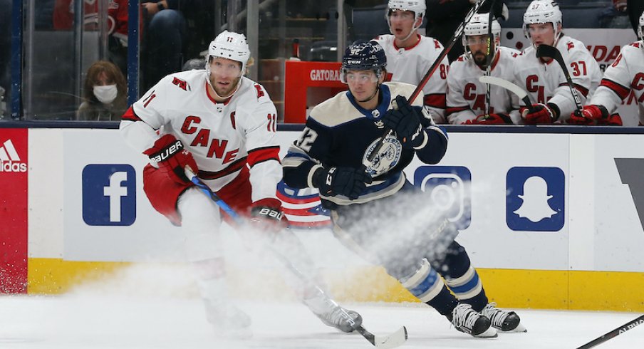 Alexandre Texier and Jordan Staal battle for the puck in the first period at Nationwide Arena.