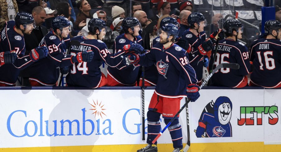 Jan 8, 2022; Columbus, Ohio, USA; Columbus Blue Jackets right wing Oliver Bjorkstrand (28) celebrates with teammates on the bench after scoring a goal against the New Jersey Devils in the first period at Nationwide Arena.