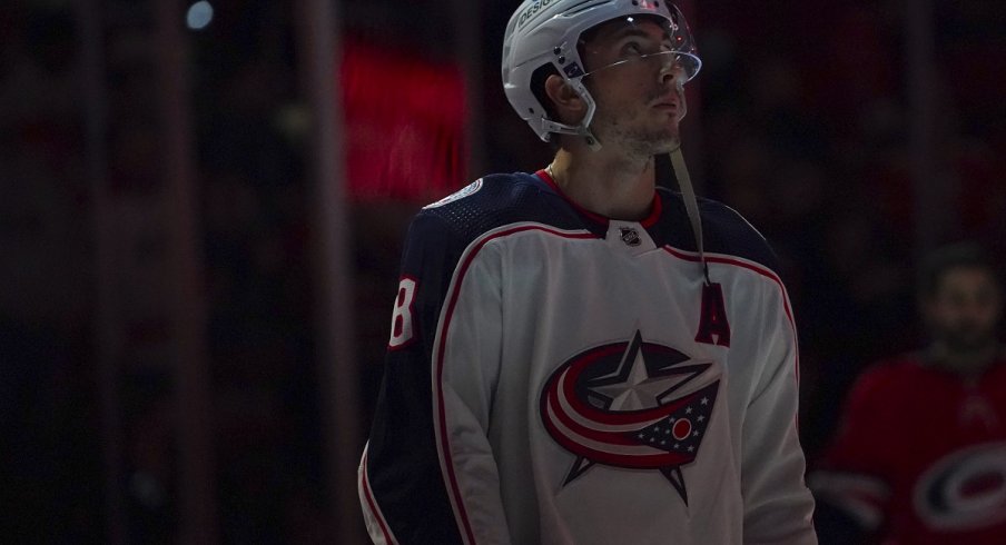Zach Werenski looks on before a game against the Carolina Hurricanes at PNC Arena