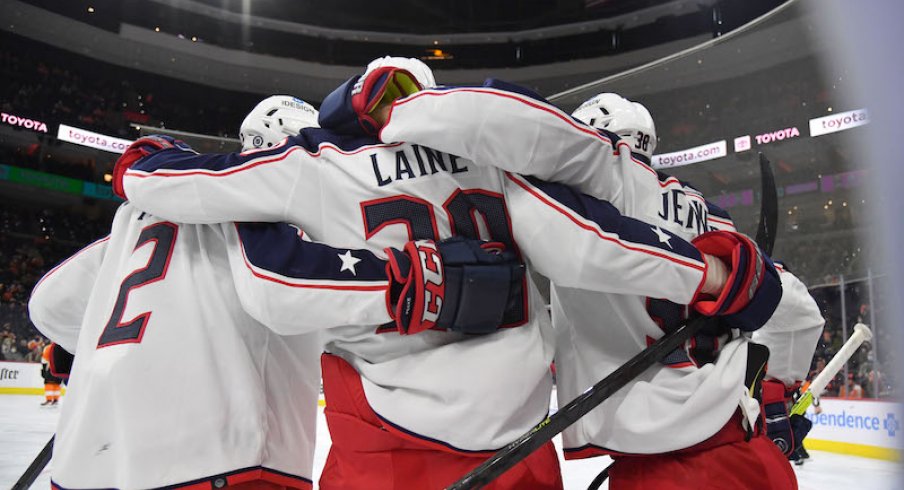 Columbus Blue Jackets' Patrik Laine celebrates his goal with Andrew Peeke and Boone Jenner against the Philadelphia Flyers at Wells Fargo Center.