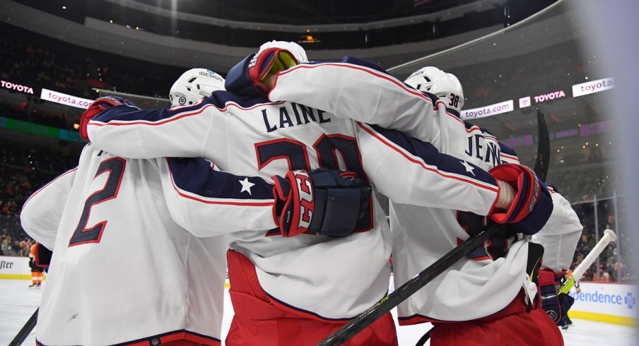 Patrik Laine celebrates his goal with defenseman Boone Jenner and Andrew Peeke