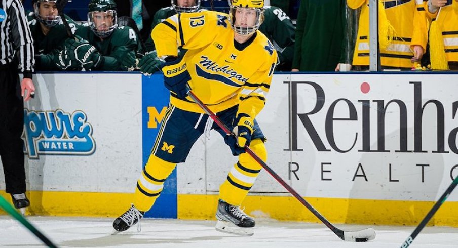 Columbus Blue Jackets prospect Kent Johnson playing a hockey game for University of Michigan.