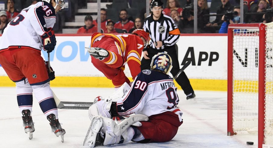 Feb 15, 2022; Calgary, Alberta, CAN; Calgary Flames forward Tyler Toffoli (73) scores on Columbus Blue Jackets goalie Elvis Merzlikins (90) during the third period at Scotiabank Saddledome. Flames won 6-2.