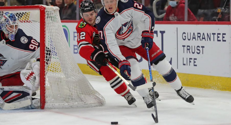 Columbus Blue Jackets defenseman Adam Boqvist skates the puck in his own territory against the Chicago Blackhawks.