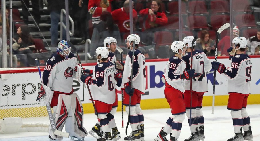 Feb 17, 2022; Chicago, Illinois, USA; The Columbus Blue Jackets celebrate their victory over the Chicago Blackhawks following the third period at the United Center.