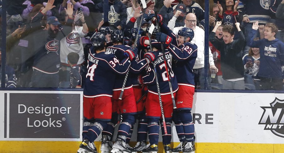 Feb 22, 2022; Columbus, Ohio, USA; The Columbus Blue Jackets celebrate the overtime win against the Toronto Maple Leafs at Nationwide Arena.