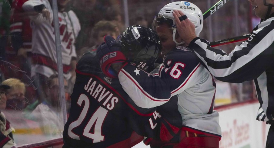 Feb 25, 2022; Raleigh, North Carolina, USA; Columbus Blue Jackets center Max Domi (16) and Carolina Hurricanes center Seth Jarvis (24) battle during the first period at PNC Arena.