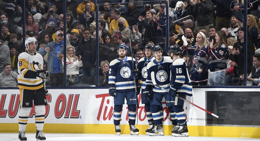 Jack Roslovic celebrates a goal with teammates